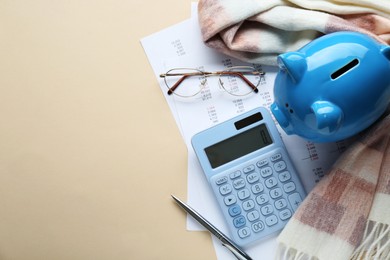 Photo of Flat lay composition with piggy bank and calculator on beige background. Space for text