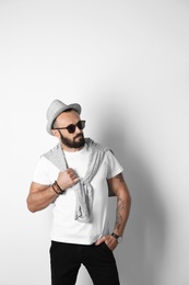 Portrait of handsome tattooed man on white background