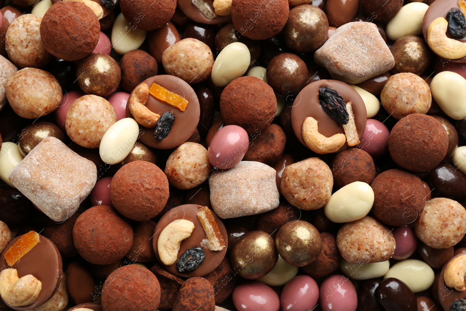 Photo of Different delicious chocolate candies as background, closeup