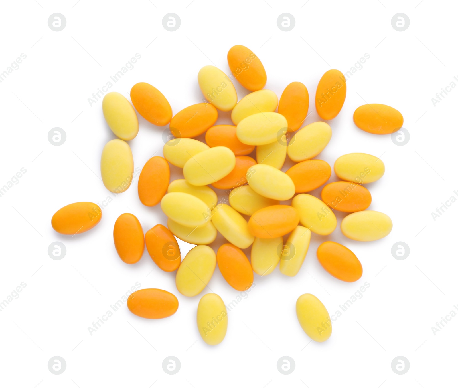 Photo of Tasty yellow and orange dragee candies on white background, top view