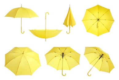 Image of Set with stylish yellow umbrellas on white background