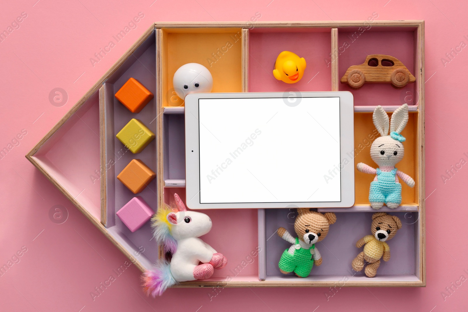 Photo of Modern tablet and kid's toys on pink background, flat lay. Space for text