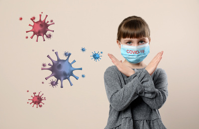 Little girl wearing medical mask on beige background. Virus protection