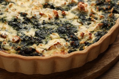 Photo of Delicious homemade spinach quiche on table, closeup