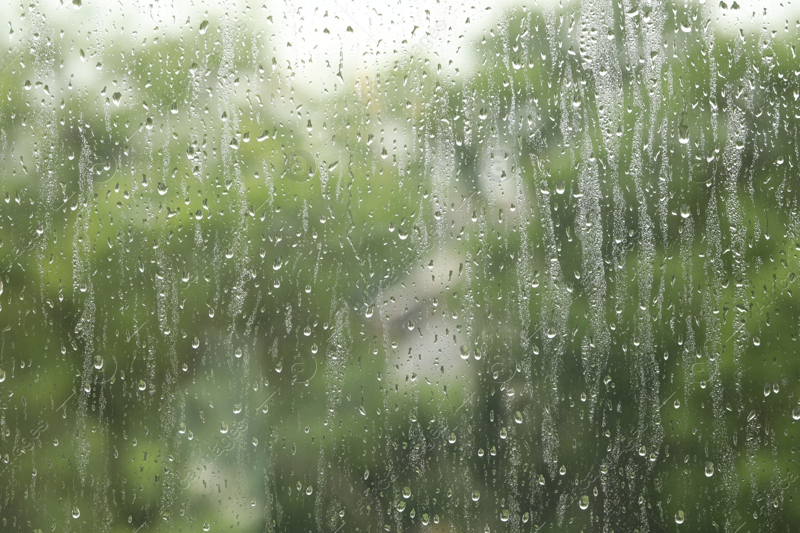 Photo of Window glass with raindrops as background, closeup