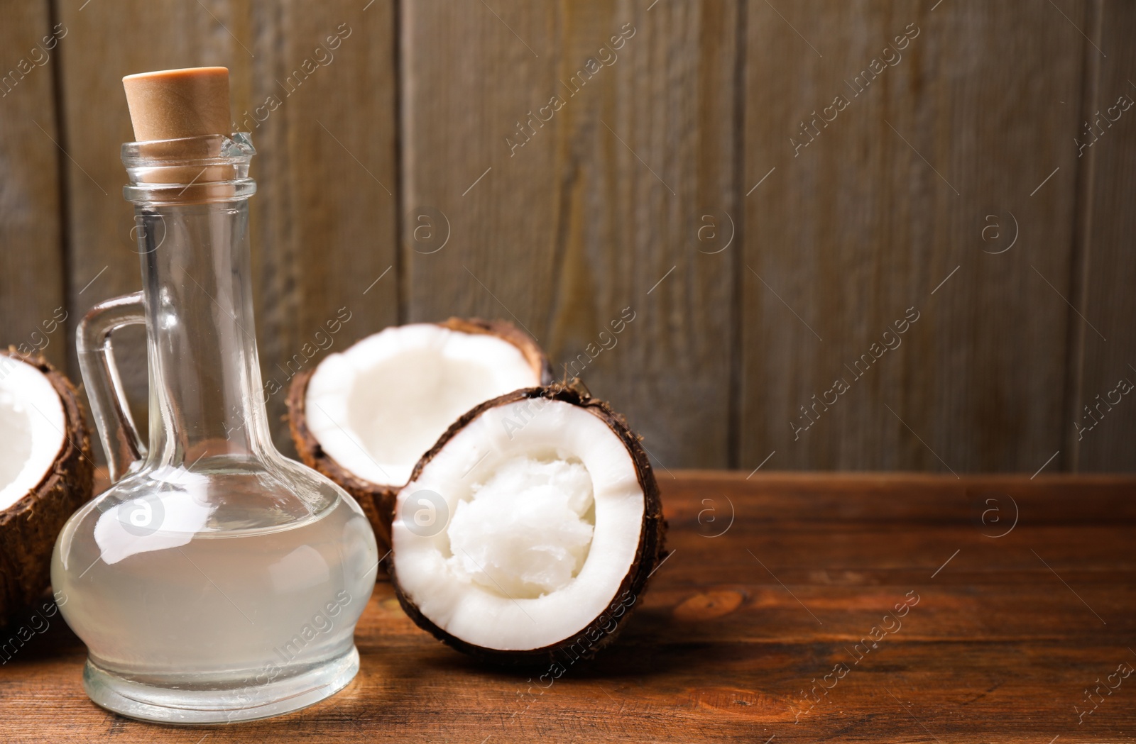 Photo of Coconut oil on wooden table. Space for text