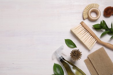 Photo of Flat lay composition with different cleaning supplies on light wooden background, space for text