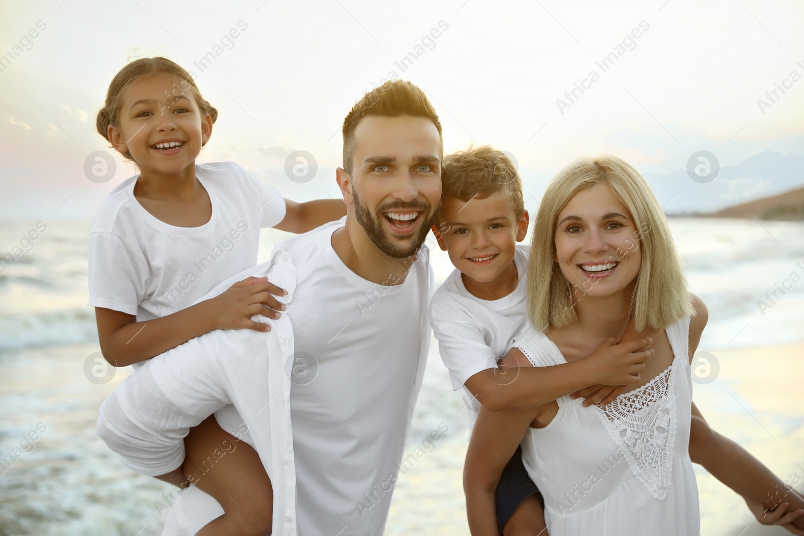 Photo of Happy family on beach near sea. Summer vacation