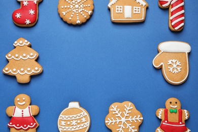 Photo of Frame made with tasty homemade Christmas cookies on blue background, flat lay. Space for text