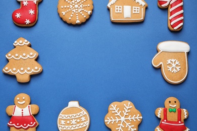 Frame made with tasty homemade Christmas cookies on blue background, flat lay. Space for text