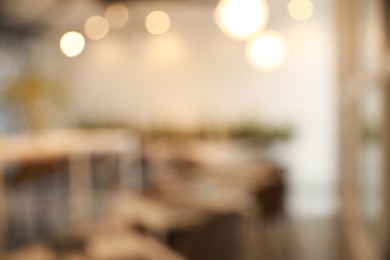 Photo of Blurred view of beautiful modern cafe interior