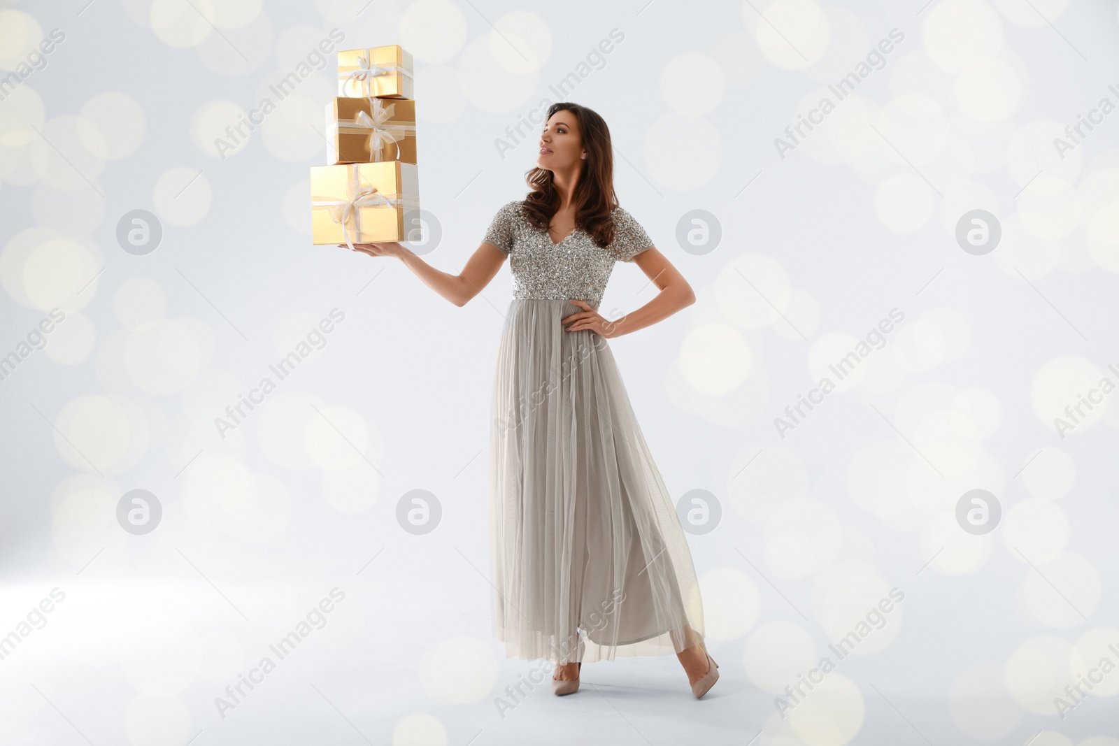 Photo of Beautiful woman with Christmas gifts on white background