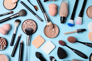 Photo of Flat lay composition with skin foundation, powder and beauty accessories on color background