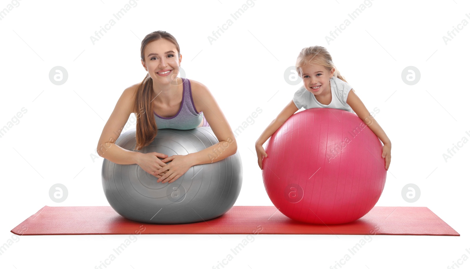 Photo of Young woman and her daughter doing exercise isolated on white. Home fitness