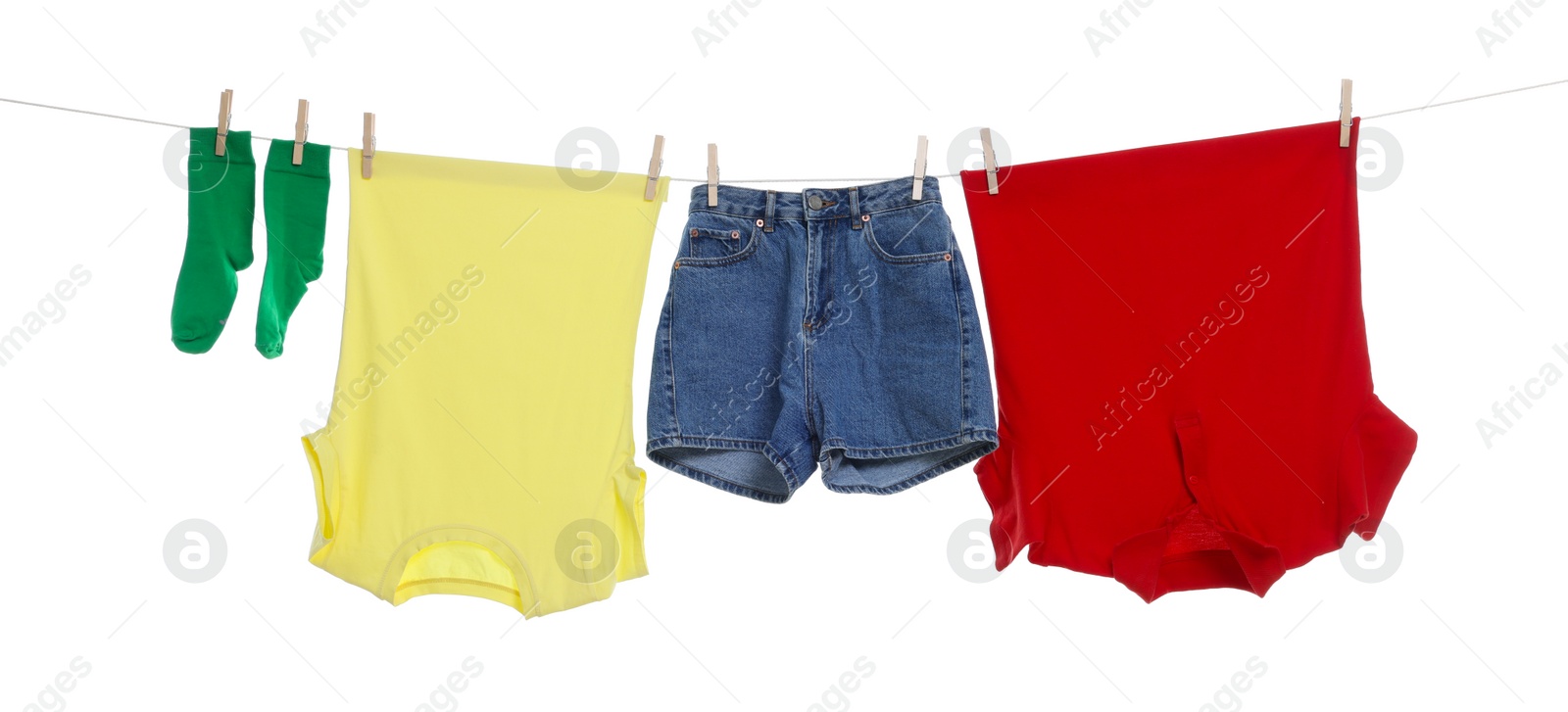 Photo of Different clothes drying on laundry line against white background