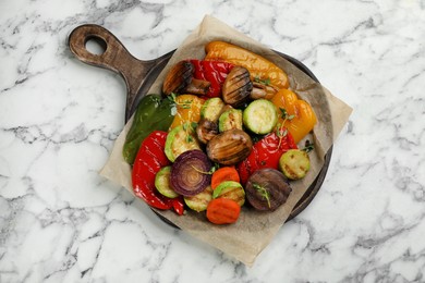 Photo of Delicious grilled vegetables on white marble table, top view