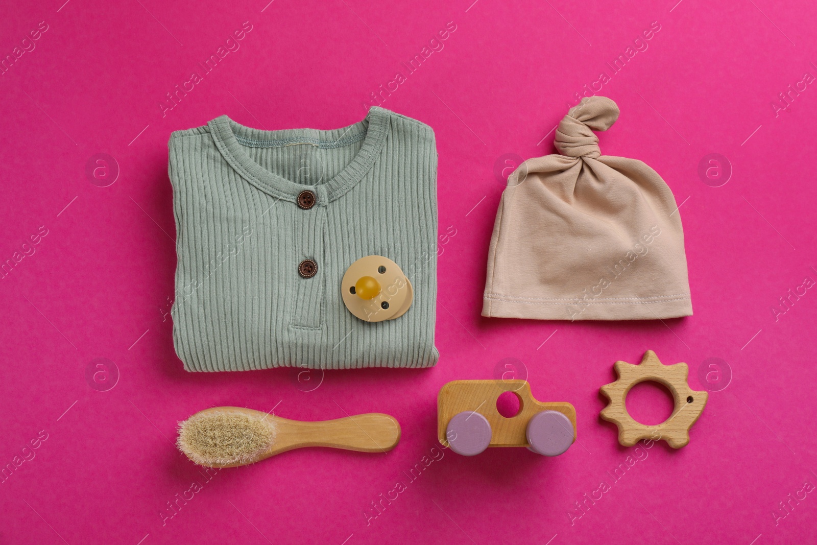 Photo of Flat lay composition with baby clothes and accessories on pink background