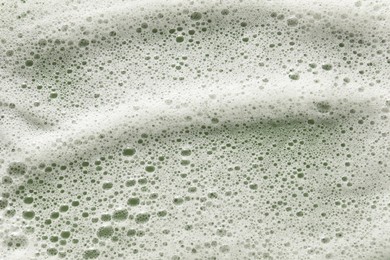 White washing foam on olive background, top view