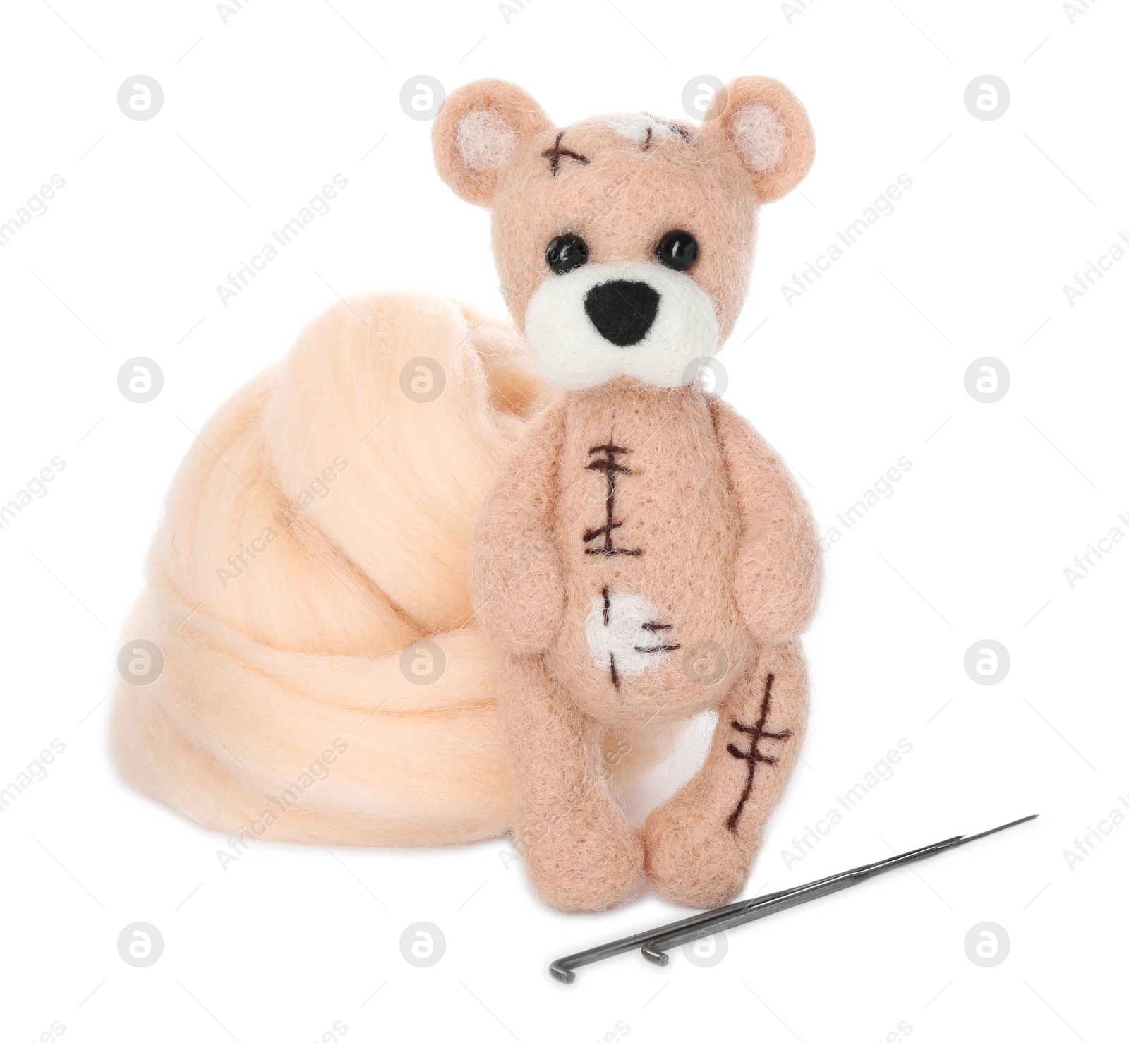 Photo of Felted bear, wool and needles isolated on white