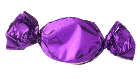 Candy in purple wrapper isolated on white