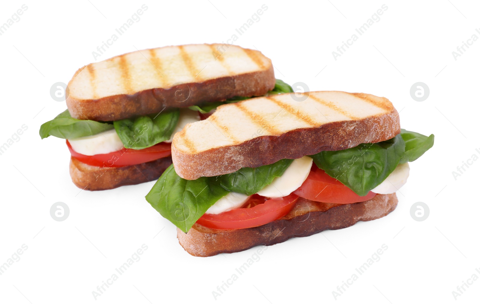 Photo of Delicious Caprese sandwiches with mozzarella, tomatoes and basil isolated on white