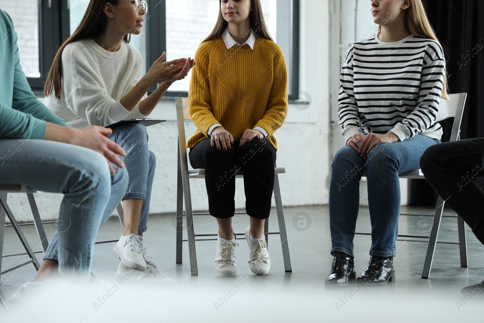 Photo of Psychotherapist working with patients in group therapy session, closeup