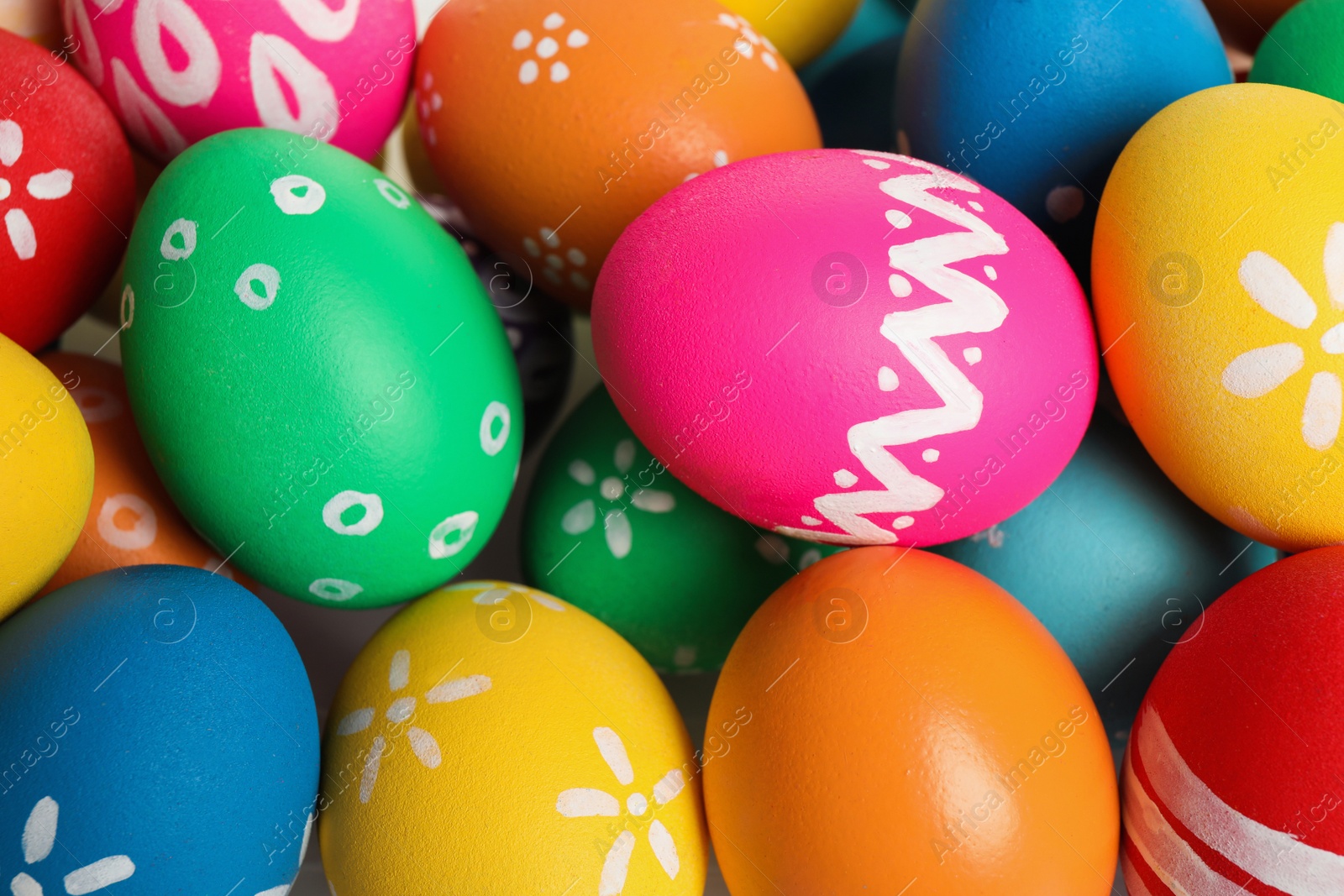 Photo of Colorful Easter eggs with different patterns as background, top view