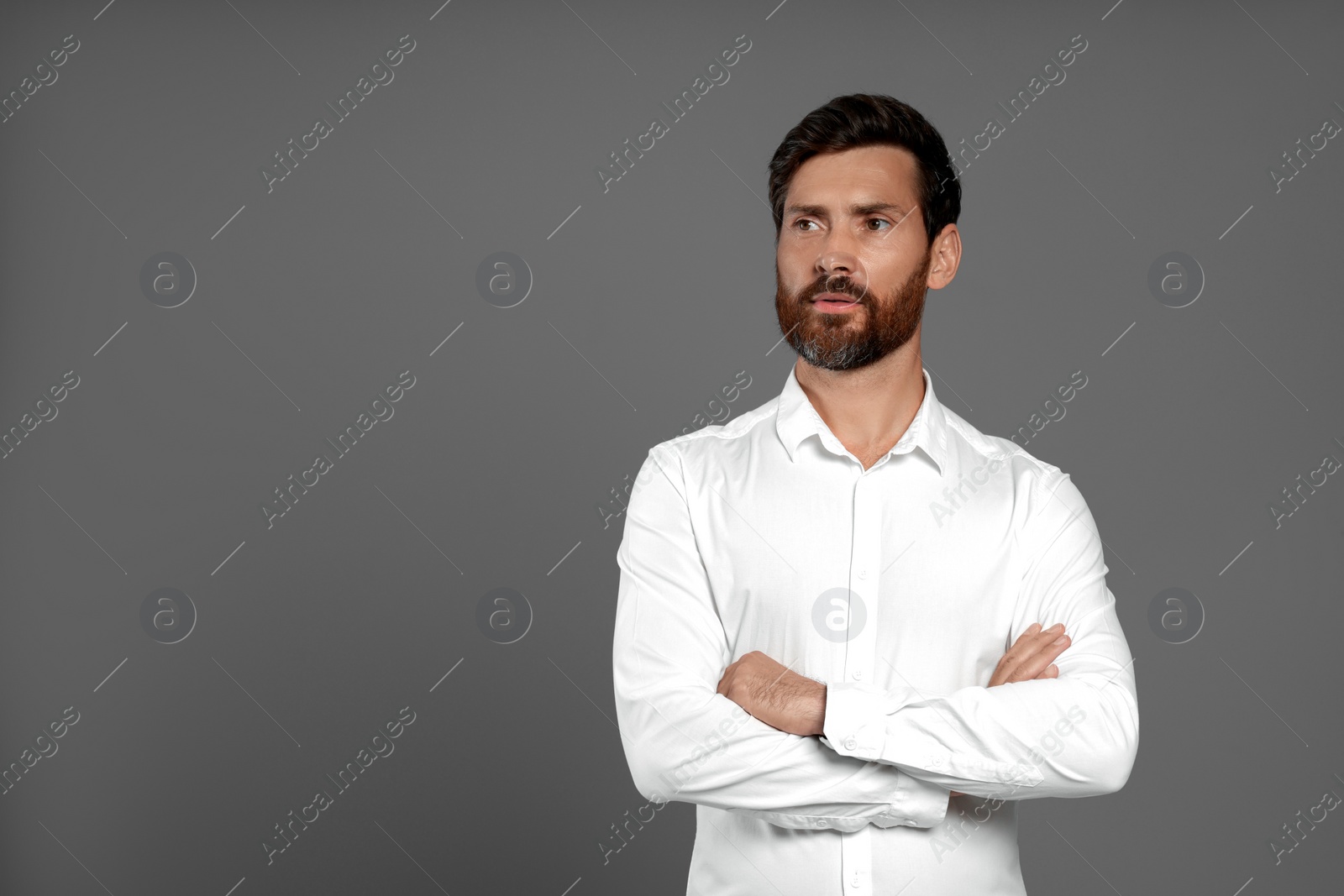 Photo of Portrait of handsome bearded man on grey background, space for text