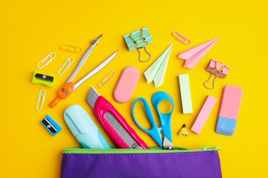 Flat lay composition with different school stationery on yellow background. Back to school