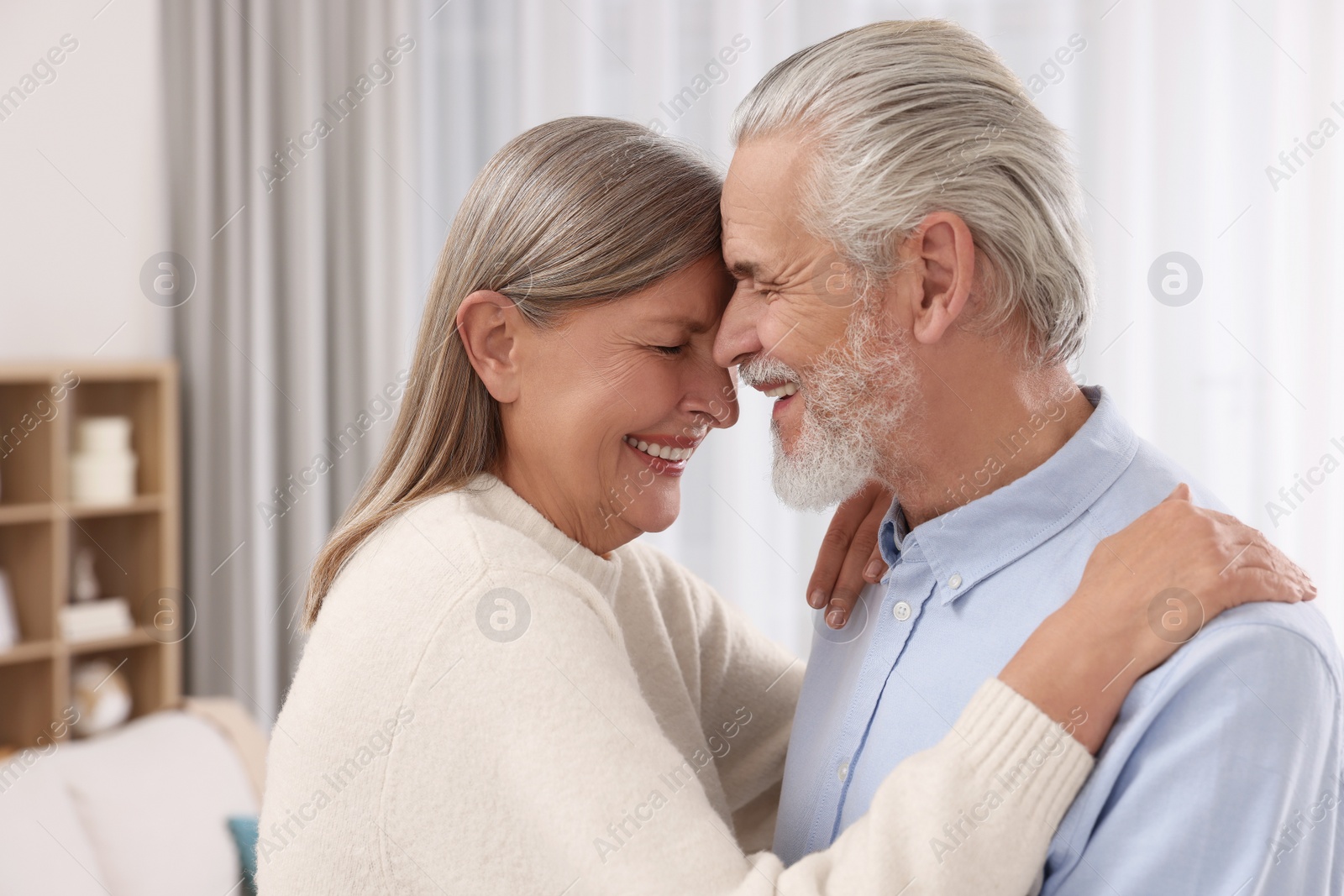 Photo of Portrait of affectionate senior couple at home