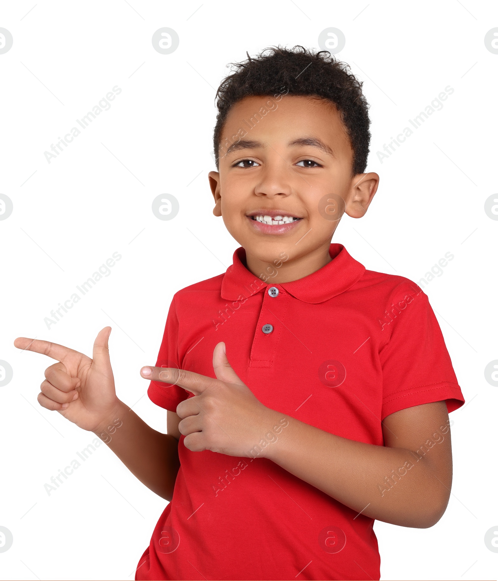 Photo of Cute African-American boy pointing on light grey background. Space for text