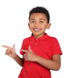 Photo of Cute African-American boy pointing on light grey background. Space for text