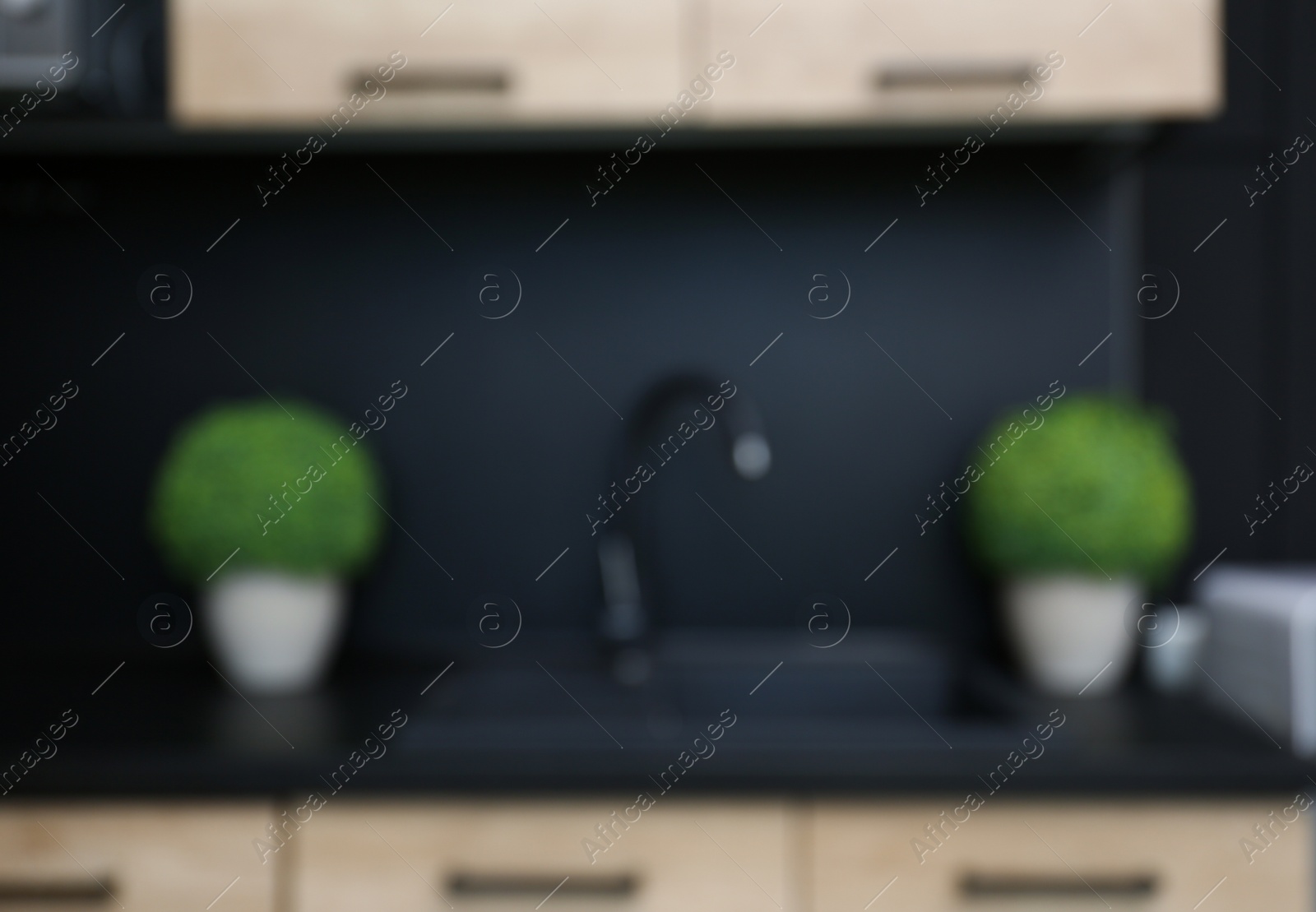 Photo of Blurred view of kitchen interior with modern furniture