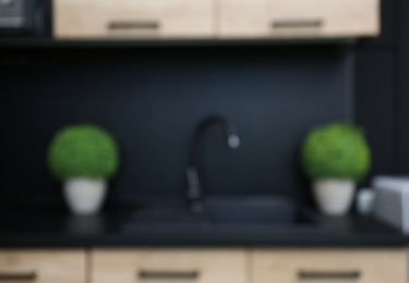 Blurred view of kitchen interior with modern furniture