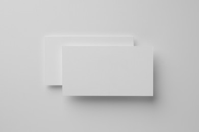 Photo of Blank business cards on white background, top view. Mockup for design