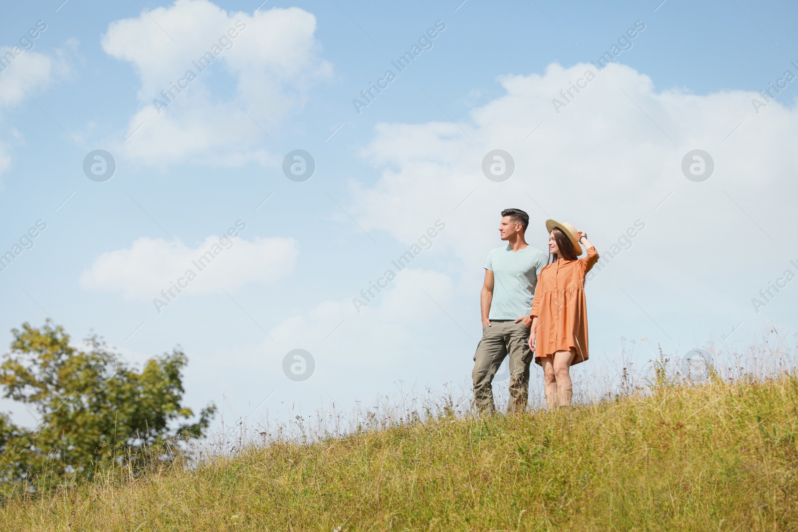 Photo of Couple spending time together on hill, space for text