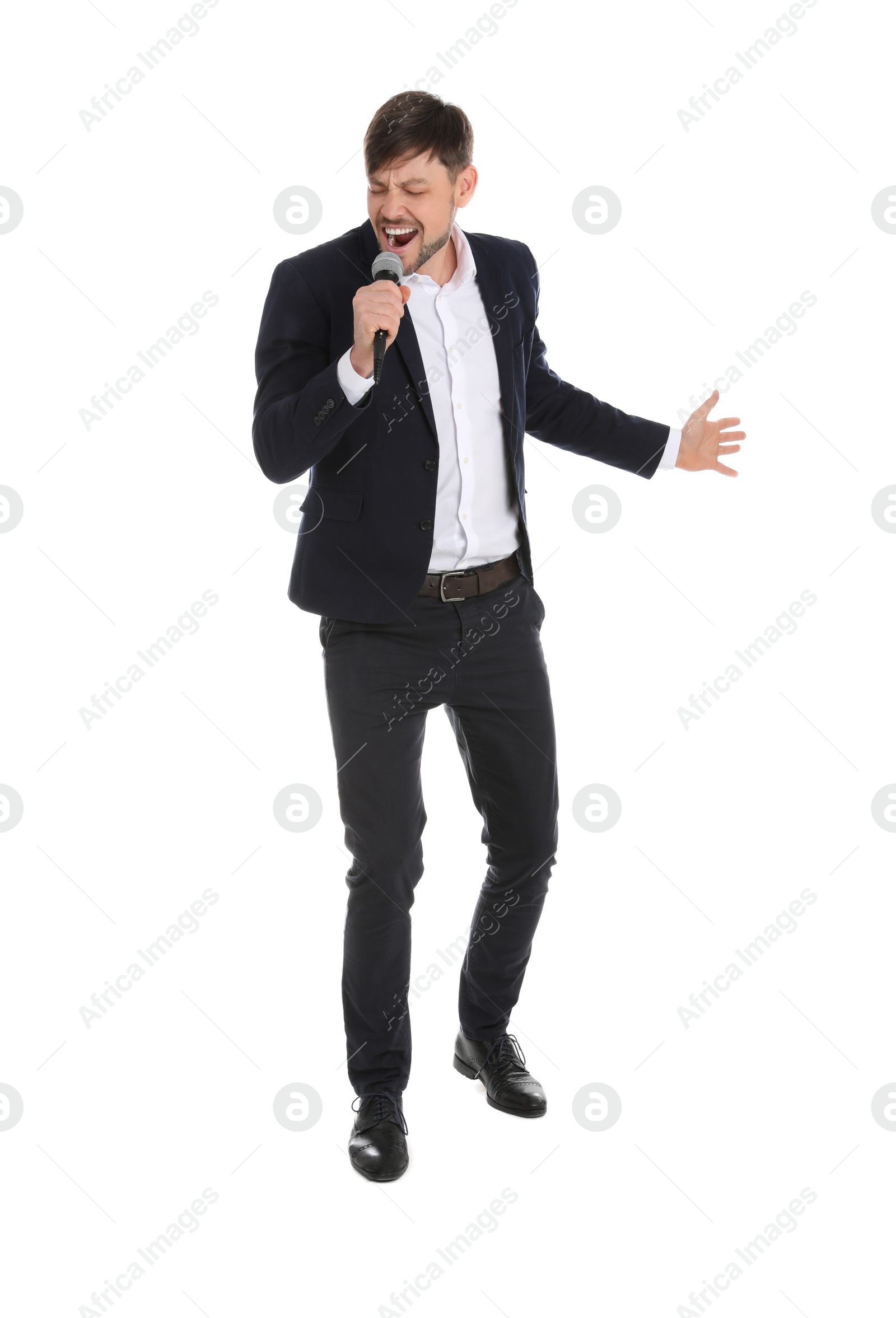 Photo of Handsome man in suit singing with microphone on white background