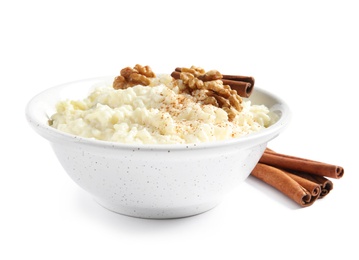 Photo of Creamy rice pudding with cinnamon and walnuts in bowl on white background
