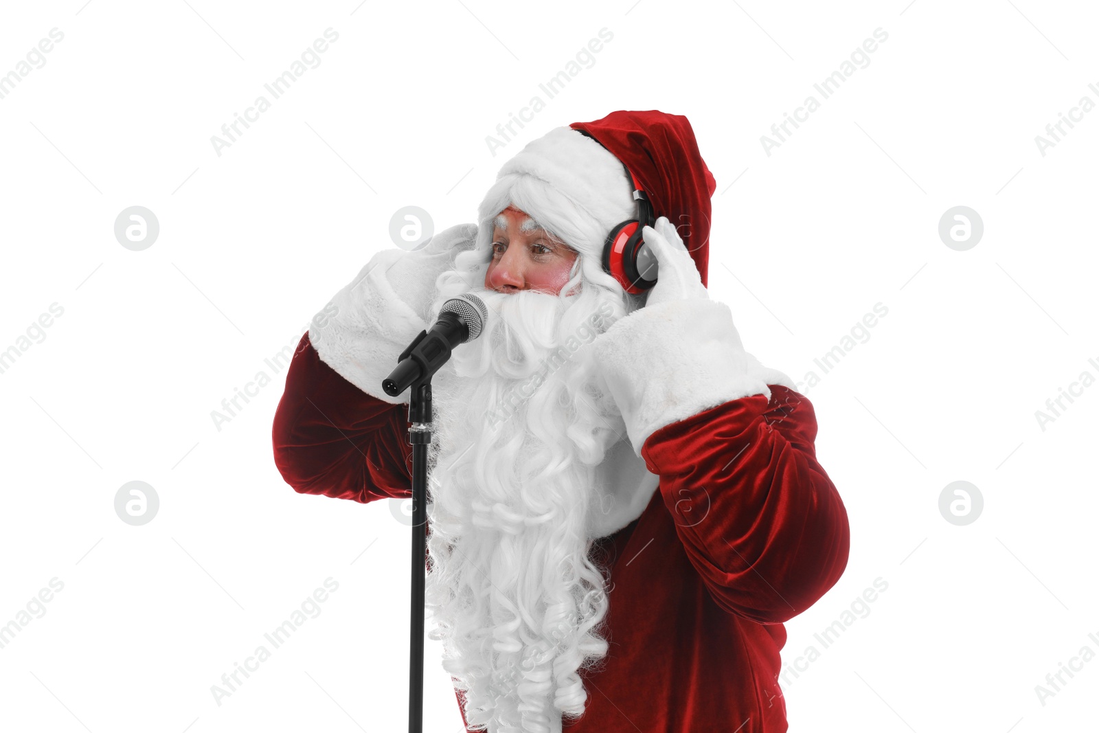 Photo of Santa Claus with headphones and microphone on white background. Christmas music