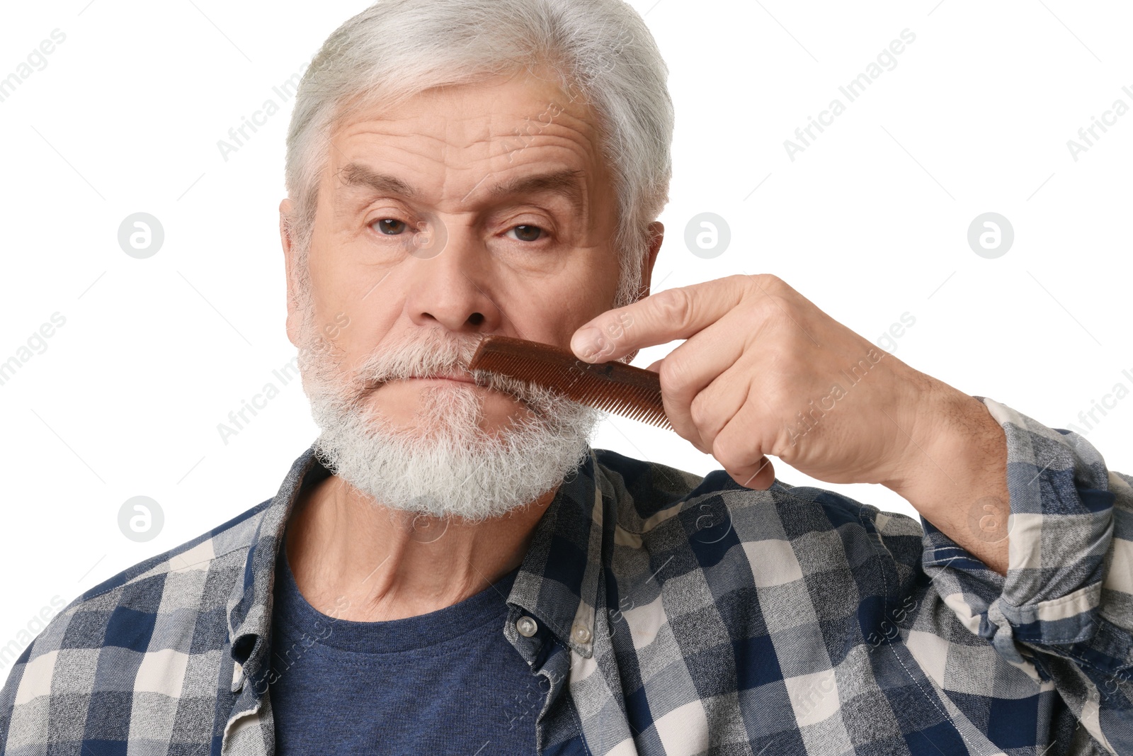 Photo of Senior man combing beard with comb on white background