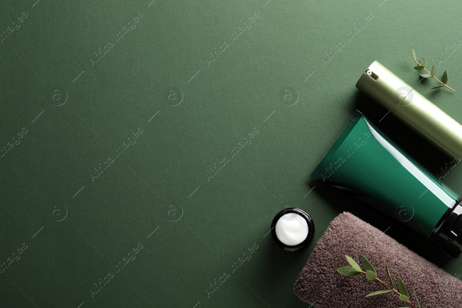 Photo of Facial cream and other men's cosmetic products on green background, flat lay. Space for text