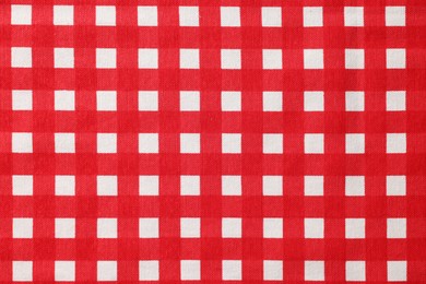 Red checkered tablecloth as background, top view