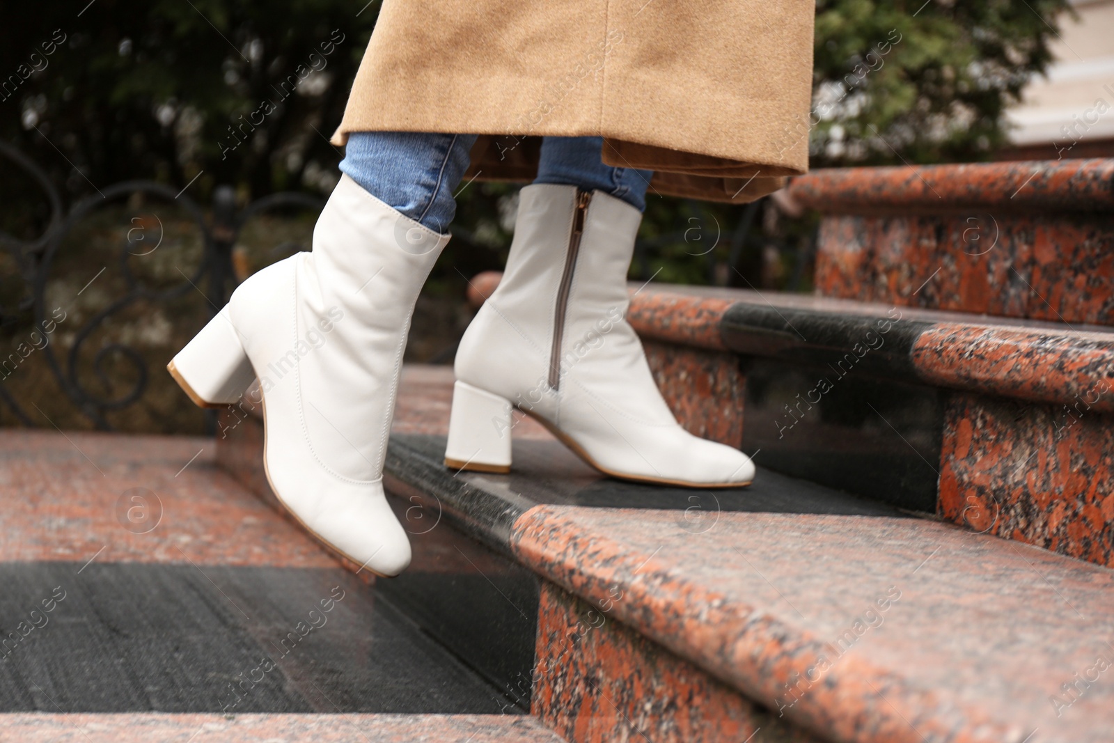 Photo of Woman wearing stylish leather shoes on stairs outdoors, closeup