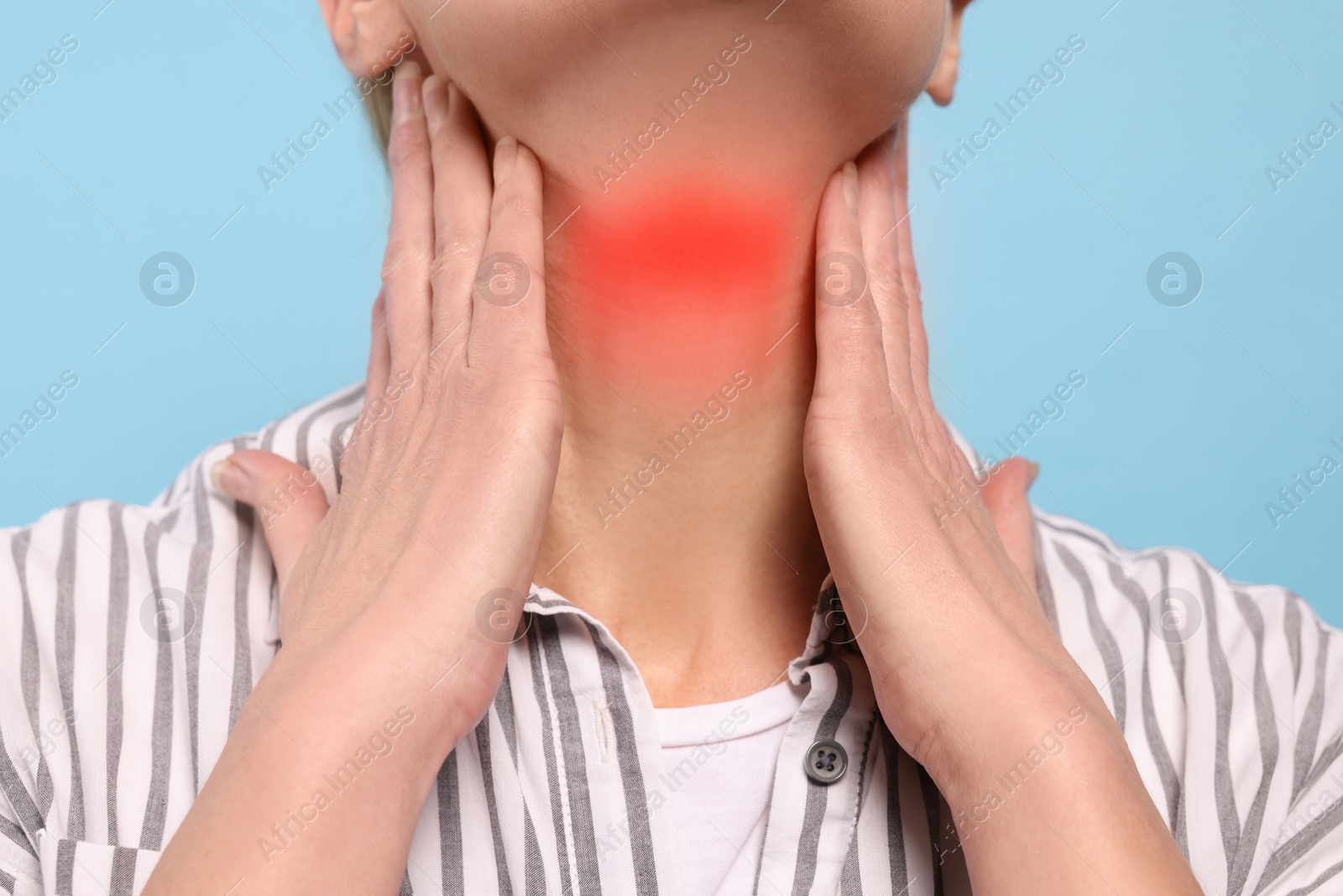 Image of Endocrine system. Woman doing thyroid self examination on light blue background, closeup