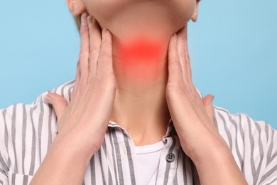 Image of Endocrine system. Woman doing thyroid self examination on light blue background, closeup