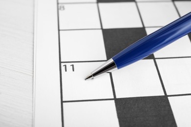 Pen on blank crossword, closeup. Space for text