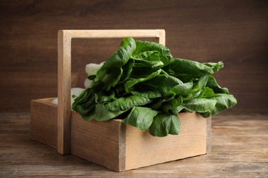 Photo of Fresh green pak choy cabbages in crate on wooden table