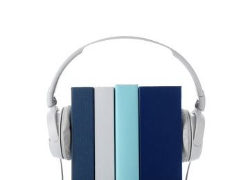 Photo of Modern headphones with hardcover books on white background, closeup