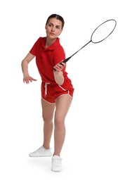 Young woman playing badminton with racket on white background