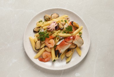 Photo of Delicious pasta with sea food on light grey table, top view